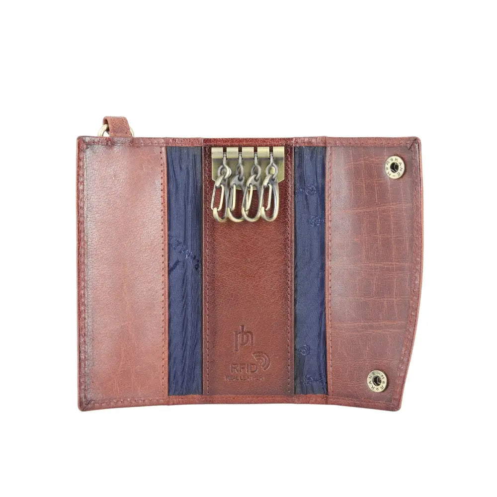 Front view of Brown leather key case with gold accents on a white background