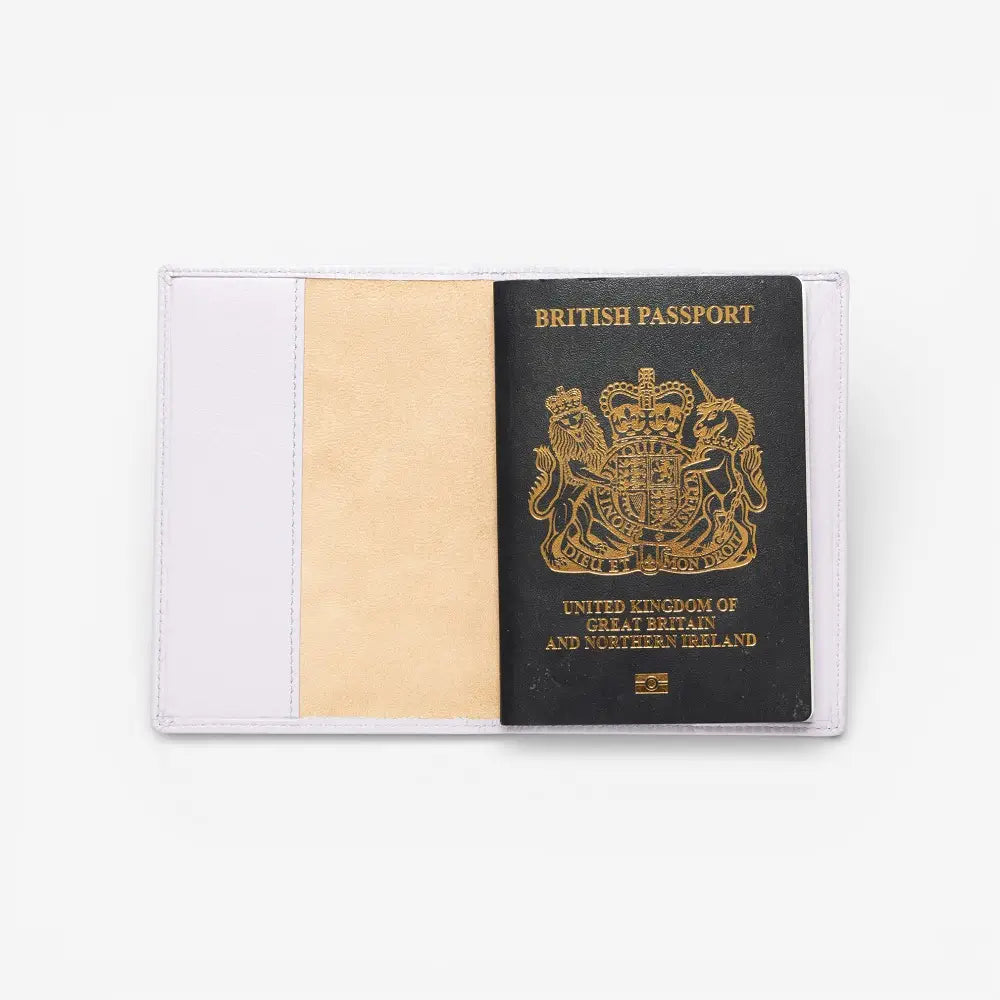 Lilac Passport cover with a British passport inside on a white background