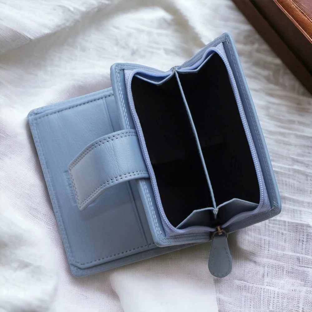 Light blue wallet on a white textured surface