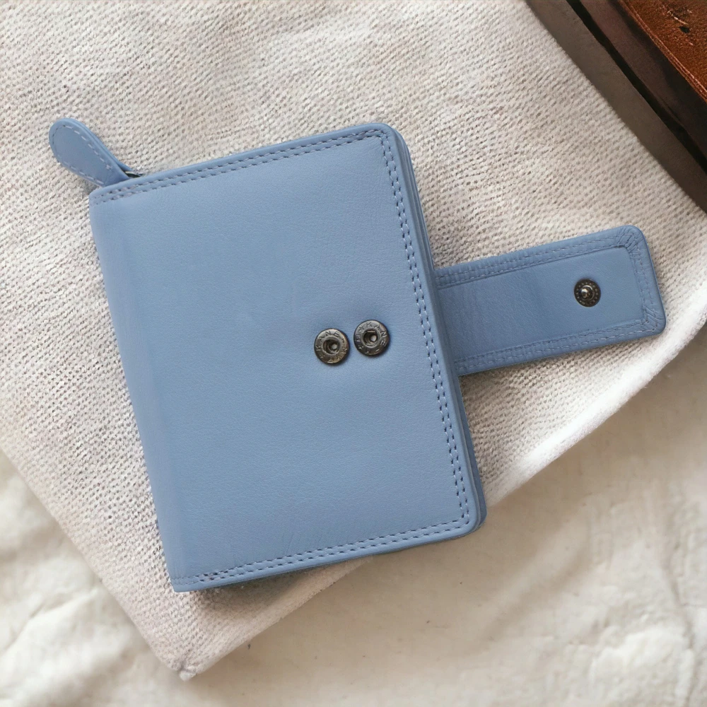 Blue leather wallet on a textured beige surface