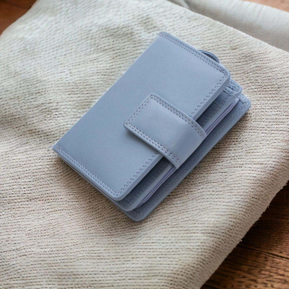 Light blue wallet on a textured beige surface