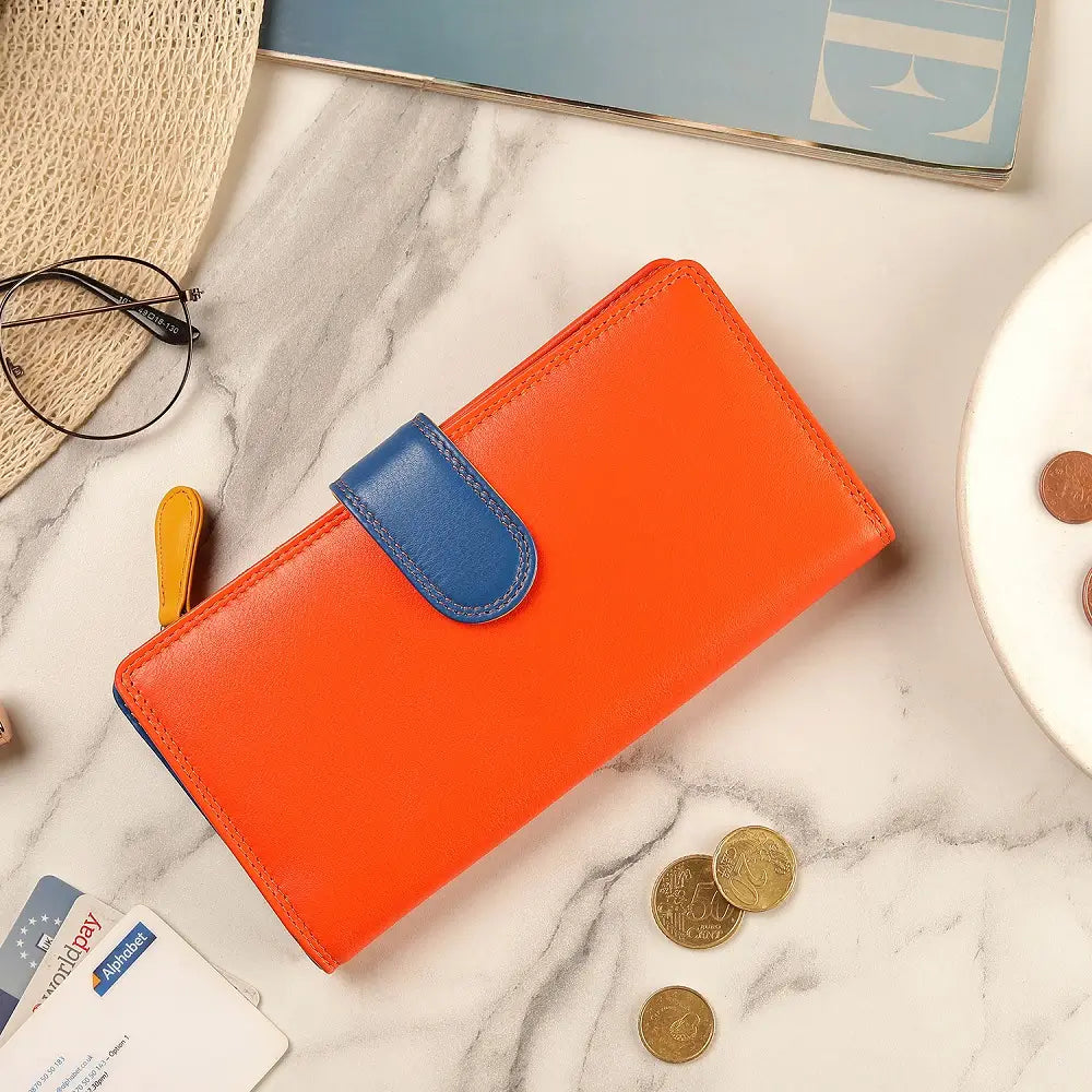 Orange wallet with blue flap on a marble surface with coins and cards.