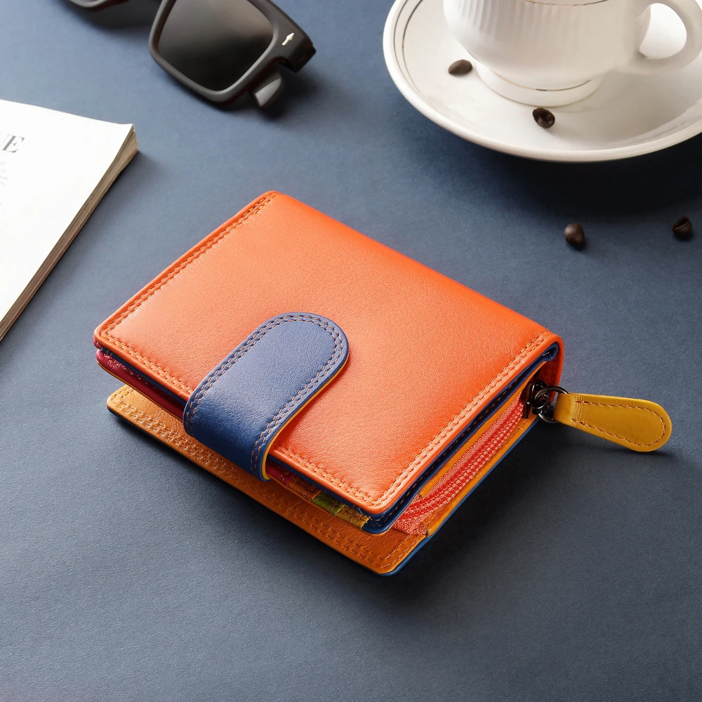 Orange and blue wallet on a gray surface with a cup and saucer in the background.