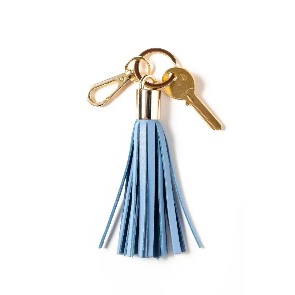 Keychain with pastel blue tassel and gold keyring on a white background