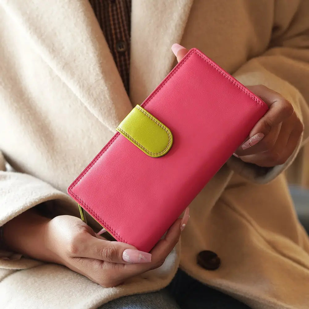 Person holding a pink wallet with a green accent