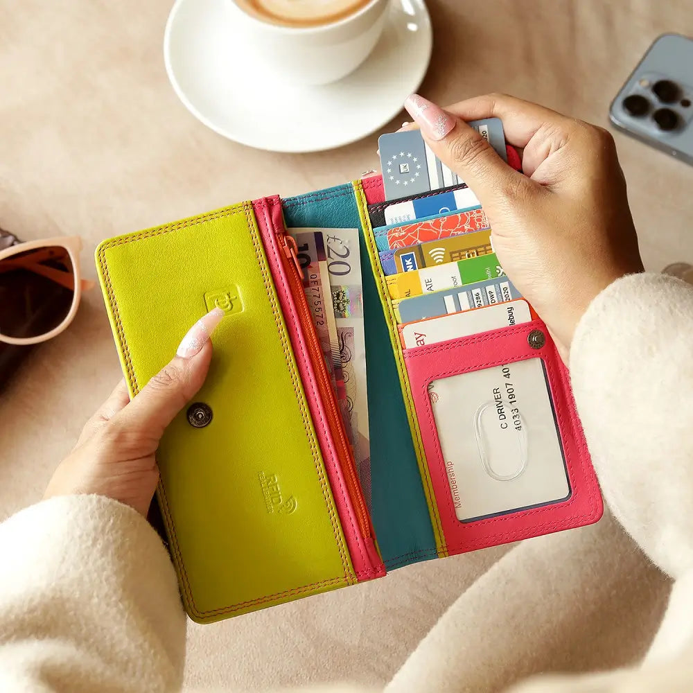 Lifestyle view of  Pink wallet with green bottom section on a white background