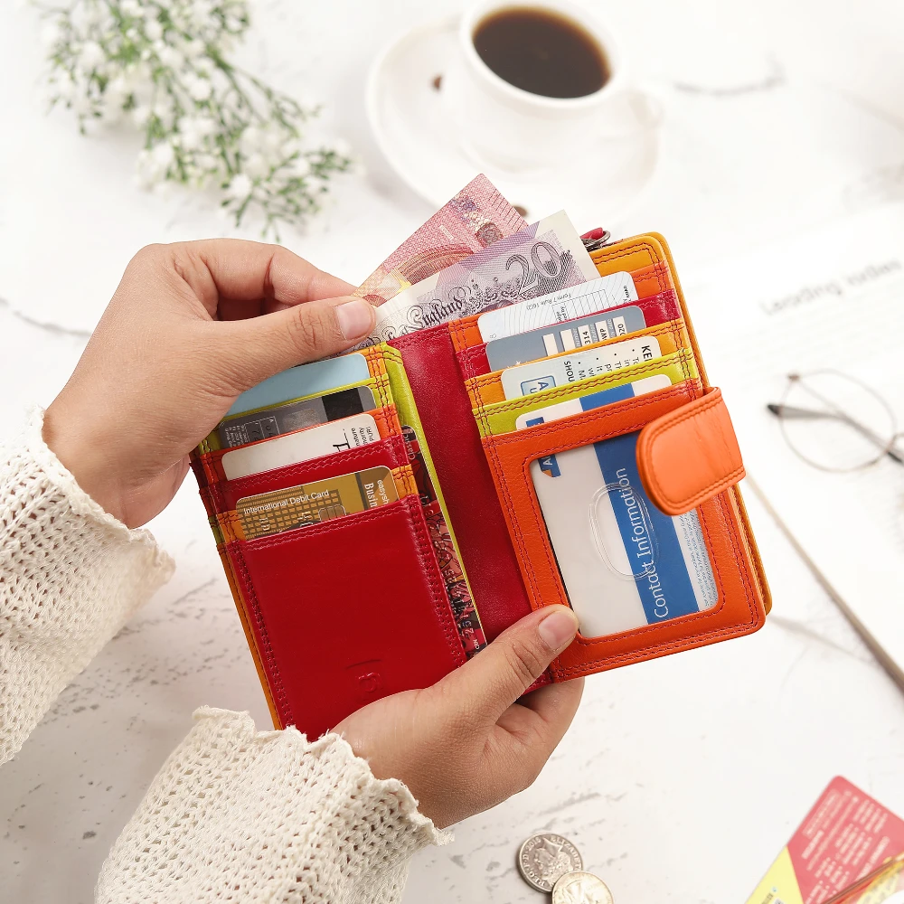 Person holding a red wallet with cards and money, with a cup of coffee in the background.
