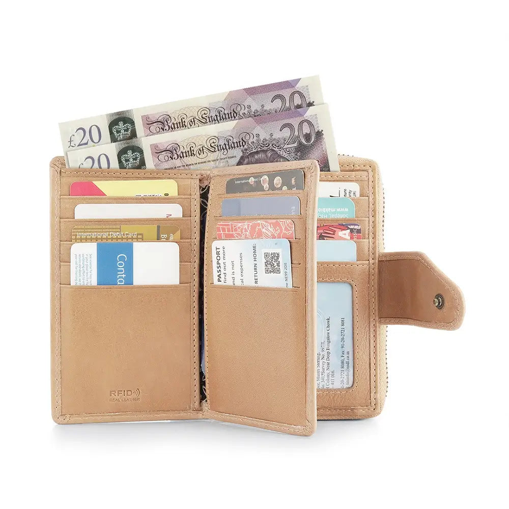 Open sand leather wallet with various cards and a 20-pound note on a white background