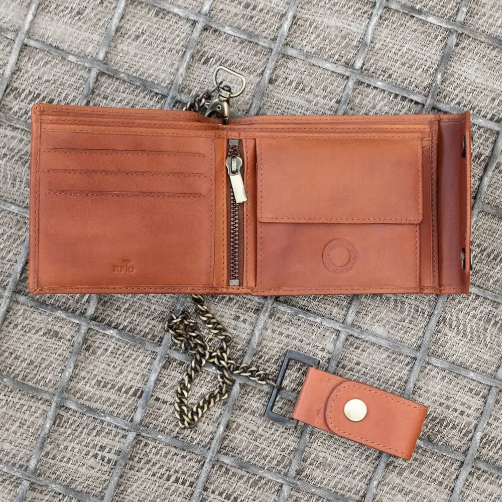 Tan leather wallet with keychain on a textured surface