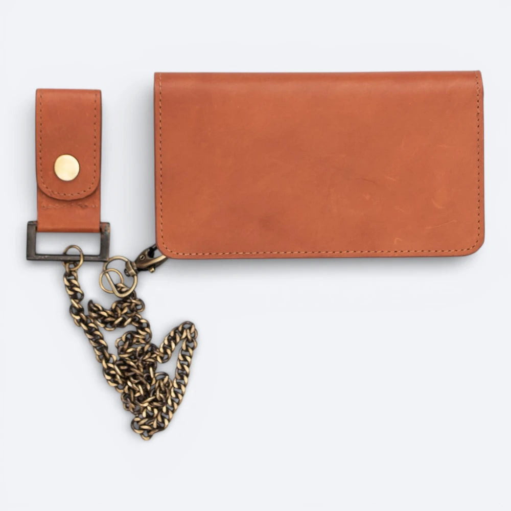 Tan leather wallet with a chain charm on a white background