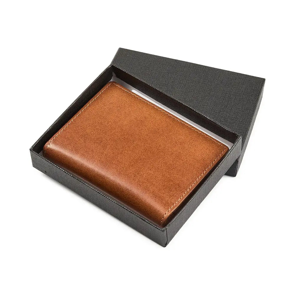 Tan leather credit card holder in a black box on a white background