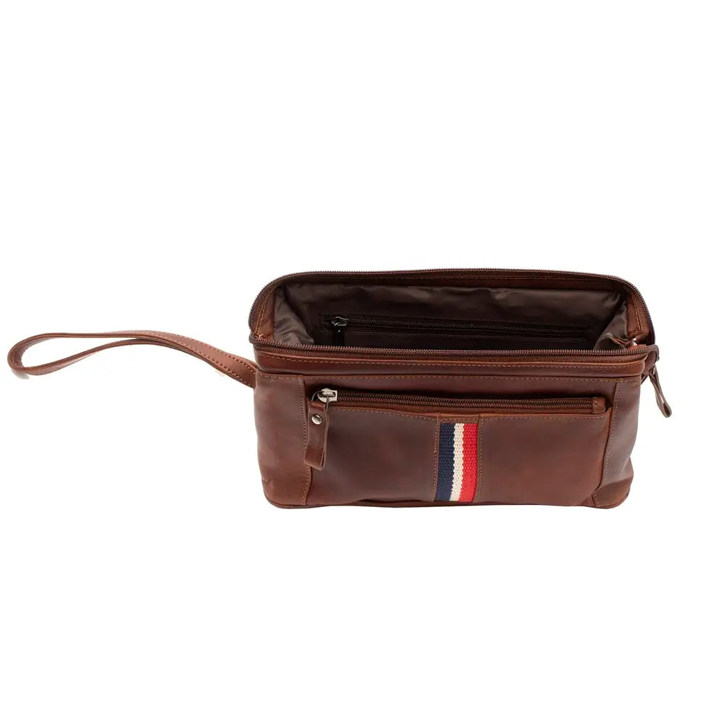A cognac washbag with a wrist strap, featuring a front pocket with a vertical red, white, and blue stripe detail, shown against a plain white background.