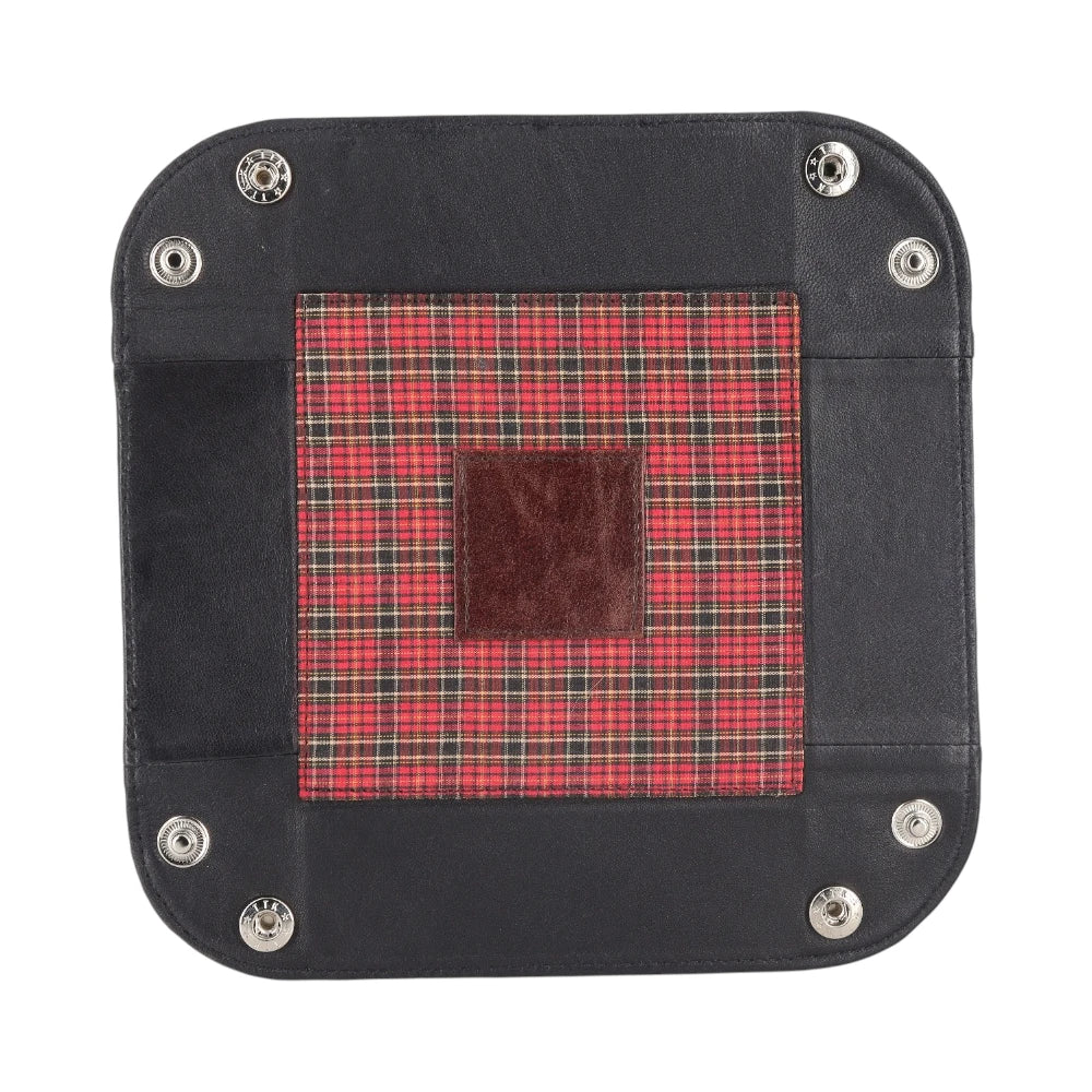 Black leather patch with a red plaid square and brown center on a white background