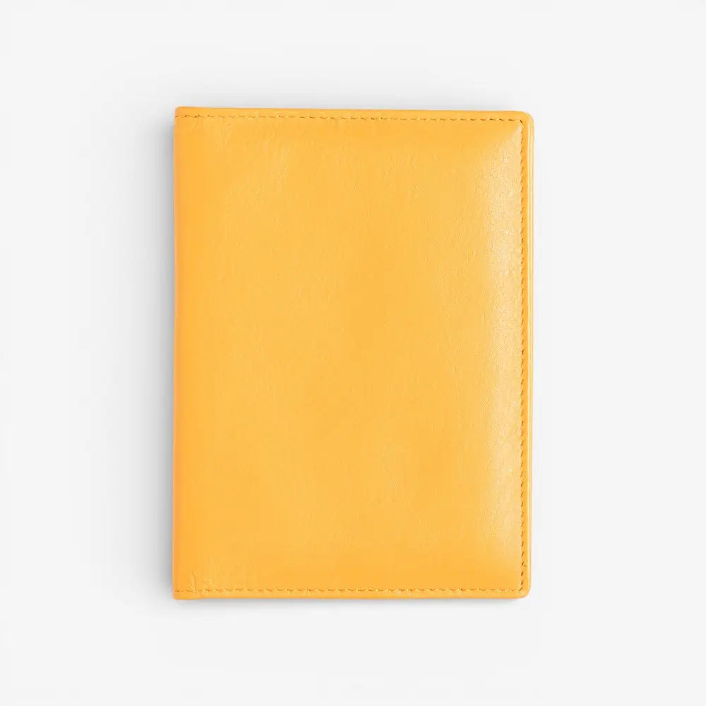 Yellow leather passport holder on a white background