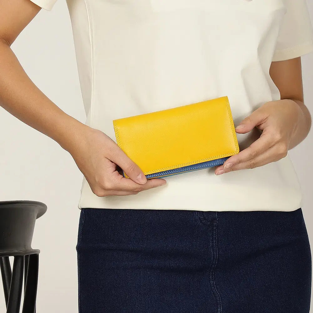 Person holding Yellow wallet with blue bottom section on a white background 