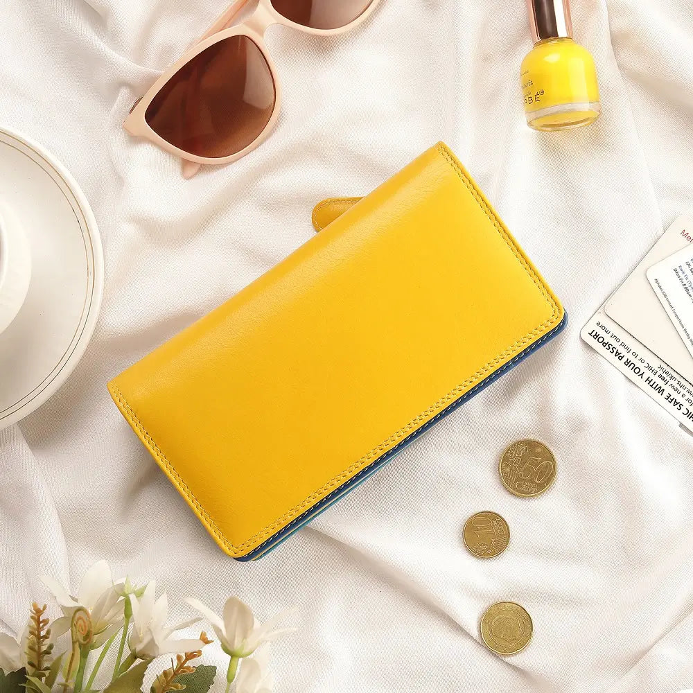 Lifestyle view of Yellow wallet with blue bottom section on a white background 