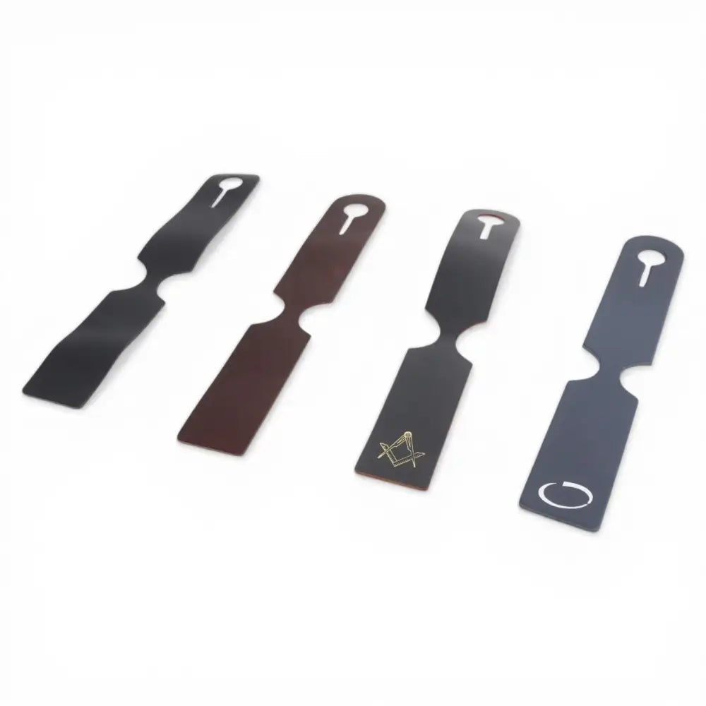Four leather luggage tag of different designs on a white background