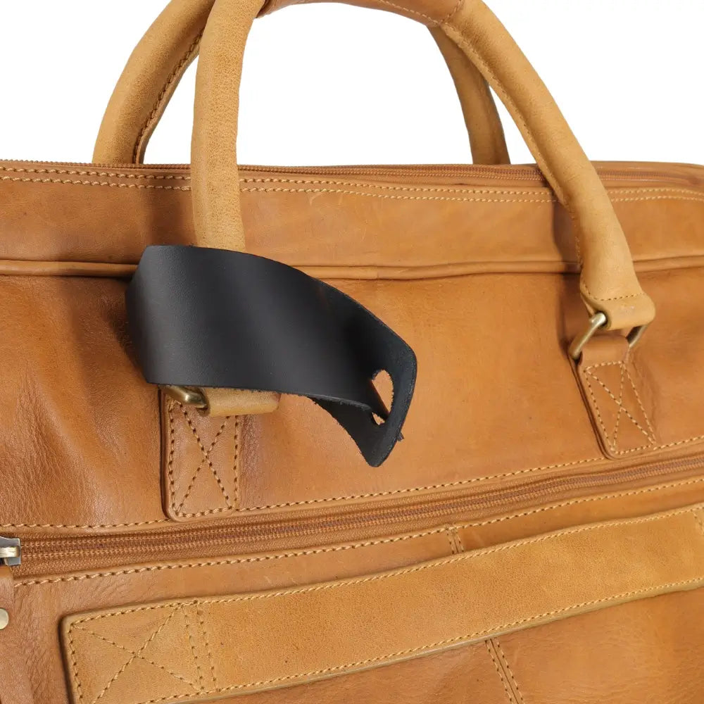 Close-up of a brown leather bag with a black tag on a white background