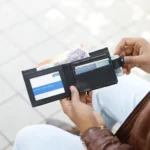 Person holding Basic Wallet Style 44, showing compact bifold wallet in hand.
