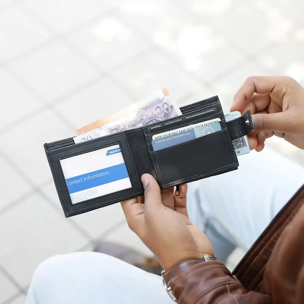 Person holding Basic Wallet Style 44, showing compact bifold wallet in hand.