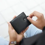 Person holding Basic Wallet Style 64 – bifold RFID safe leather wallet in hand