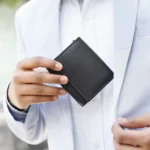 Person holding Basic Wallet Style 86 – RFID safe leather trifold wallet with ID window