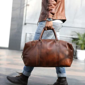 Lifestyle image of the Vintage Holdall Ridgeback 670 being carried by a model, illustrating its stylish and practical design for travel.