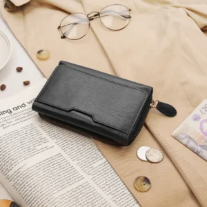 The black zip-around leather purse styled on a flat lay setup, showcasing its sophisticated design ideal for retail displays.