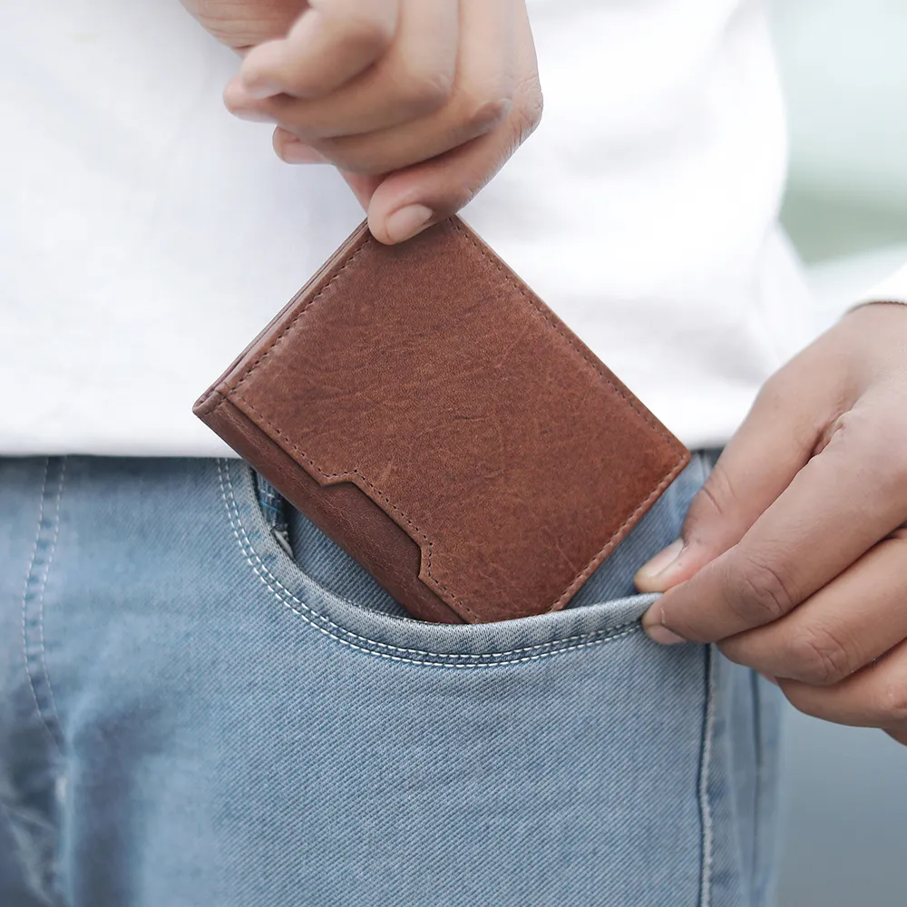 Brown leather cardholder - Alperto 4275, shown fitting into a pocket. Compact and lightweight RFID cardholder.