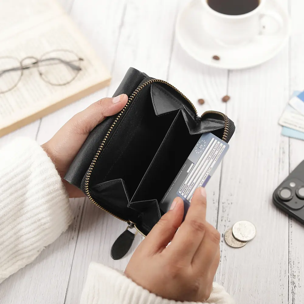 Close-up of the Medium black Trifold Purse's rear zipped coin pouch, highlighting practical design for secure coin storage.