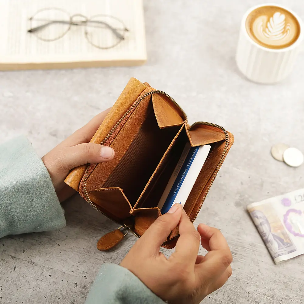 Close-up of the Medium Tan Trifold Purse's rear zipped coin pouch, highlighting practical design for secure coin storage.