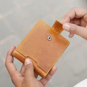 Close-up of tab button closure on the Alperto 4269 wallet in tan. Premium oiled leather with a distressed finish.