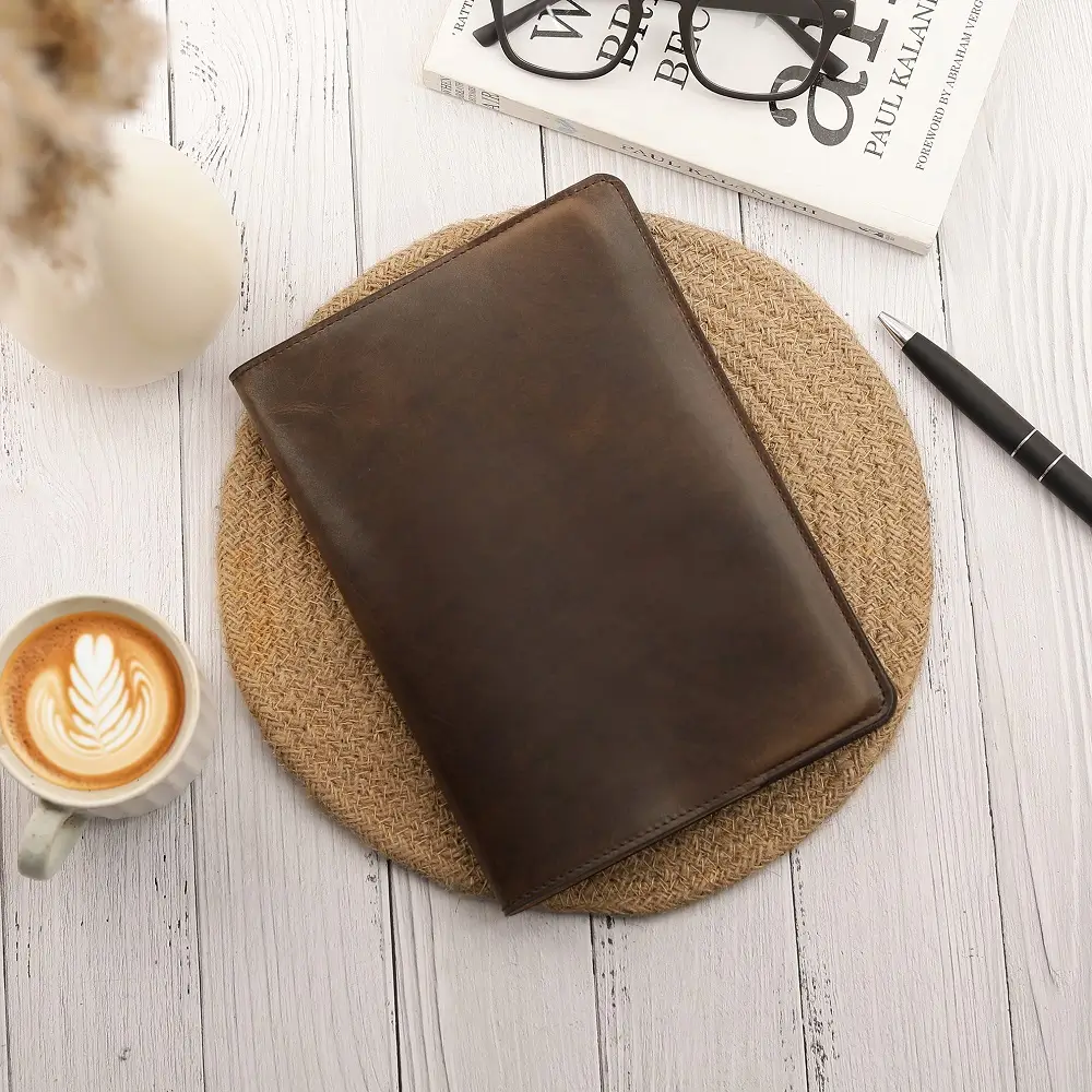 Brown Leather Diary Cover Mayfair 2519 placed on a wooden desk beside a pen and book in a lifestyle setting.