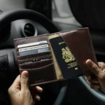 Brown leather passport wallet inside a car