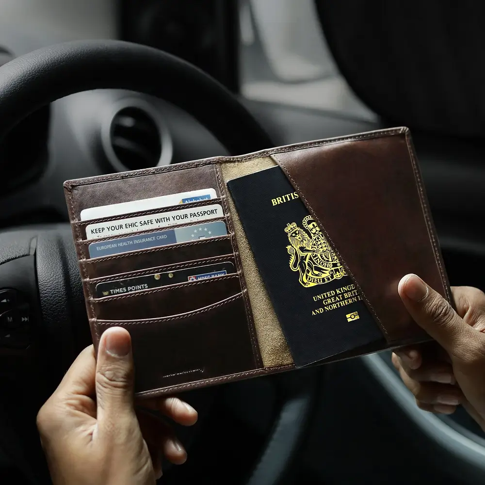 Brown leather passport wallet inside a car
