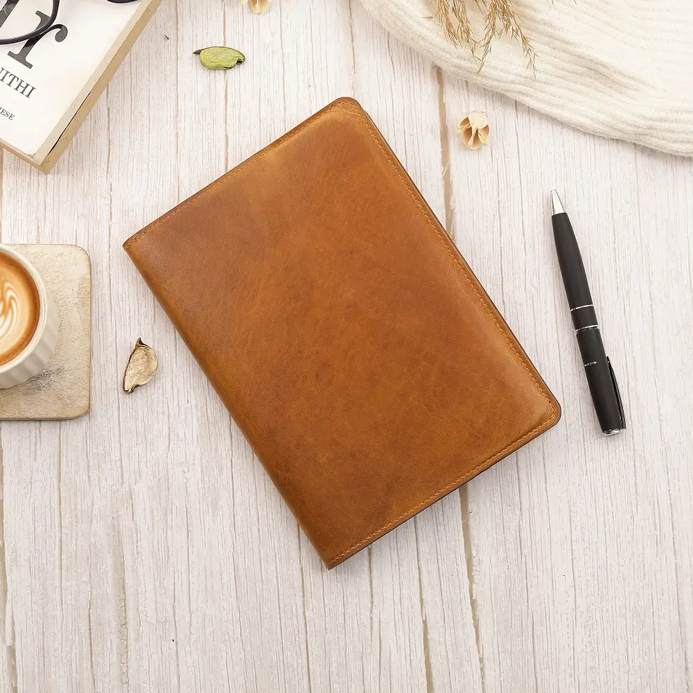 Tan Leather Diary Cover Mayfair 2519 placed on a desk beside a pen and notebook in a warm lifestyle setting.