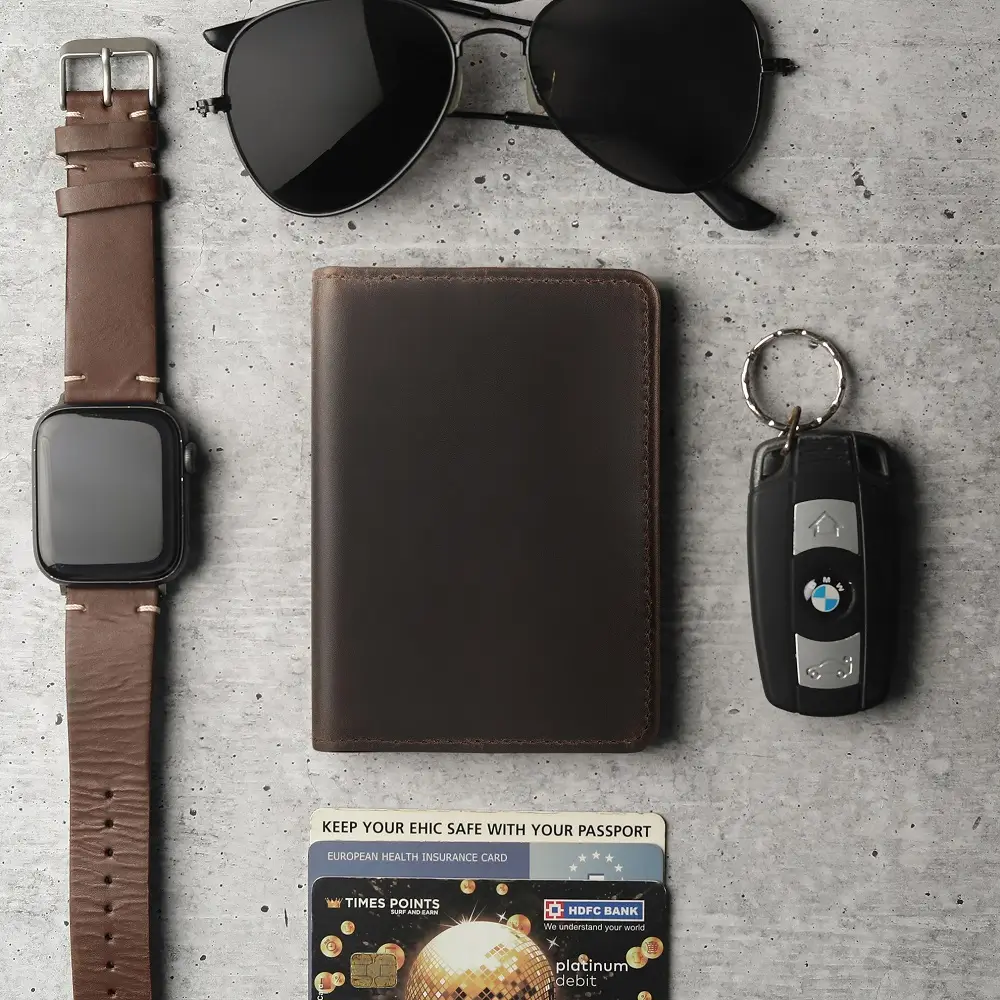 Vertical Leather-Lined Card Wallet Mayfair 2501 Brown – Lifestyle View Brown leather vertical card wallet on desk beside watch, card, glasses