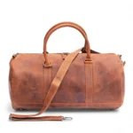 Front view of the Hunter Leather Holdall in Vintage Tan showing the classic duffel shape and front zipped pocket.